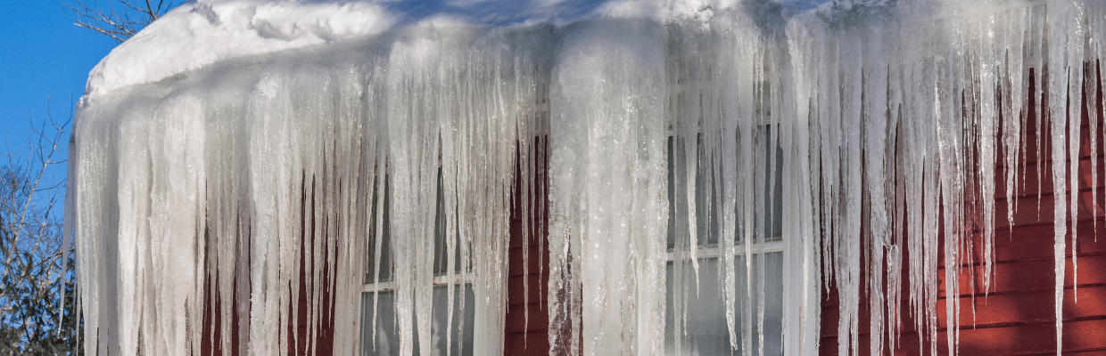 Example of a large ice dam that has formed on a red house